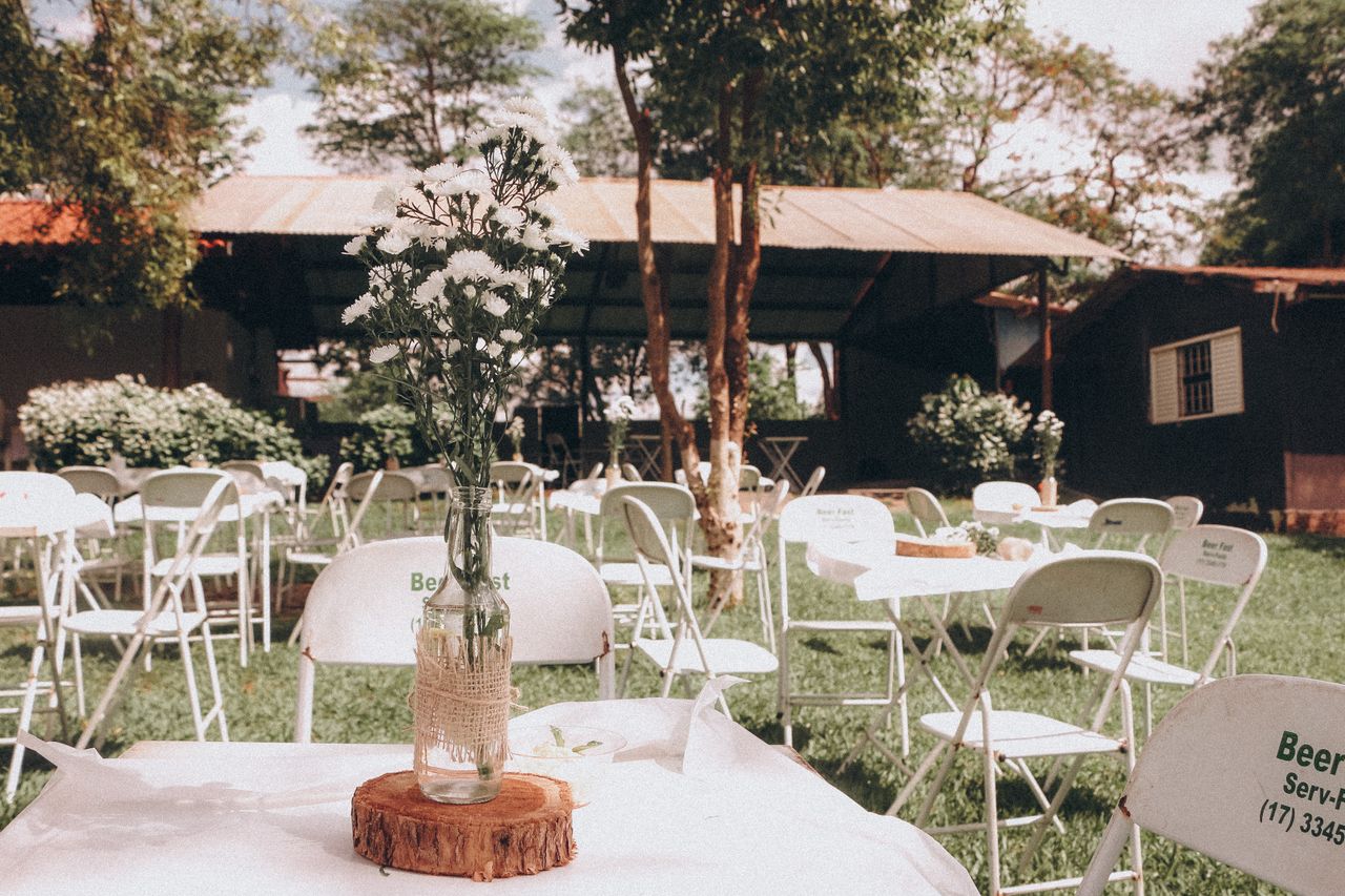 portfolio-02 Charming outdoor garden event setup with floral centerpiece on a sunny day.