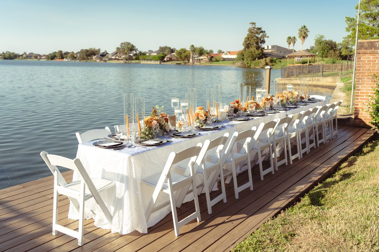 services-10 Beautifully set outdoor wedding reception on a lakeside boardwalk in New Orleans.